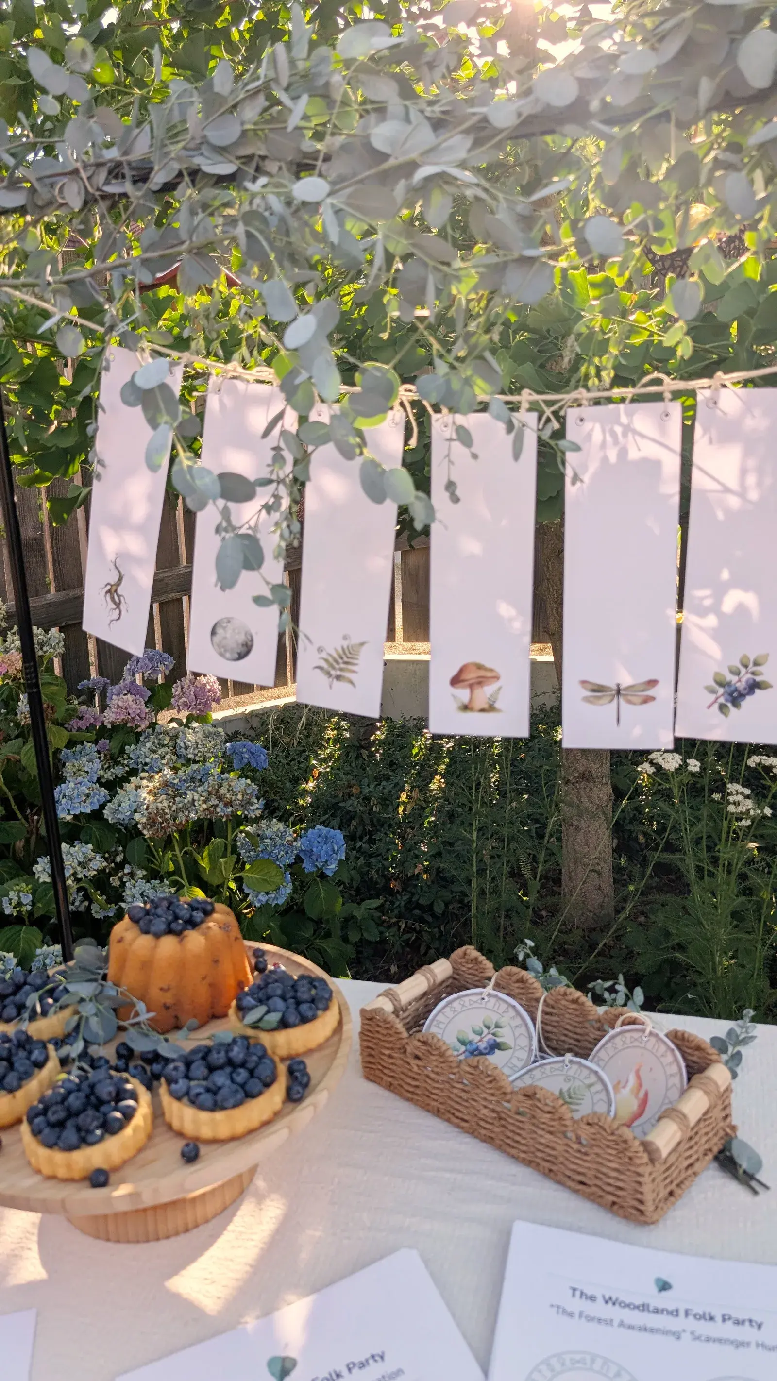 Woodland-themed birthday party kit with printable invitations, scavenger hunt, ribbon wands, and forest decorations.