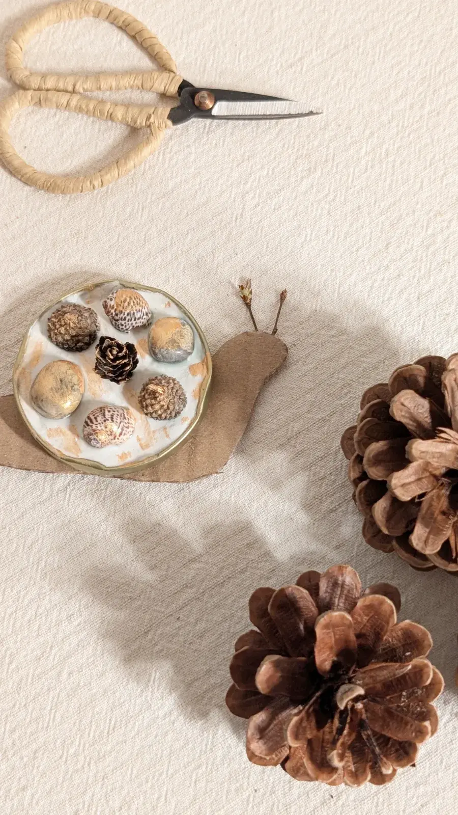 Handmade snail with a clay shell filled with nature treasures