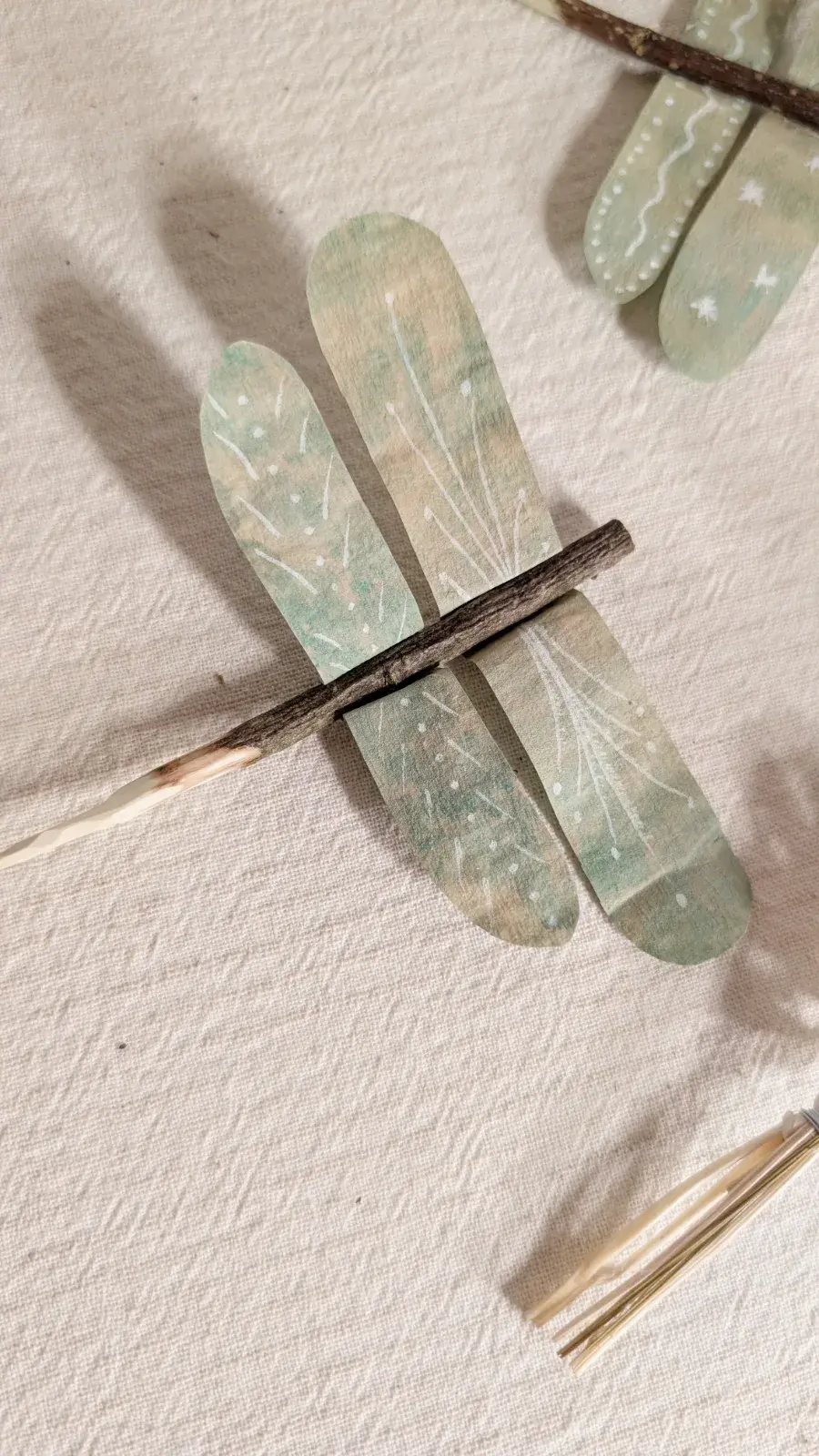 Watercolor dragonfly made from a coffee filter and small stick